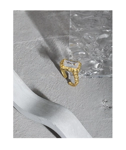 Close-up of golden S925 silver ring with hammered texture and rectangular zircon stone