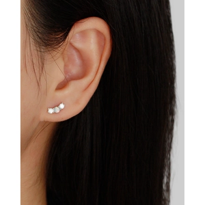 Close-up of S925 silver stud earrings featuring an opal center with zircon side stones