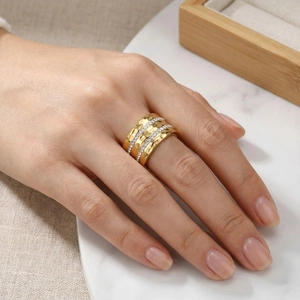 Detail of wide hammered gold titanium ring with double rows of zircons on a model