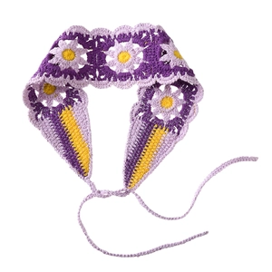 Macro shot of purple knit floral headband featuring handmade crochet daisy patterns