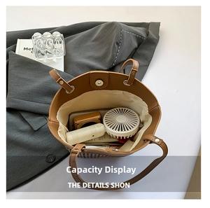 Interior view of checkered canvas bucket bag with drawstring liner showing storage capacity