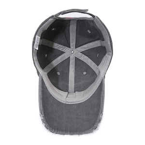 Inside view of grey washed cotton baseball cap showing 100% cotton label and stitching