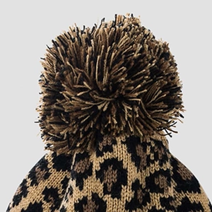 Winter leopard print knitted beanie with fluffy pom-pom detail and thick texture