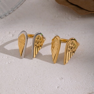 Macro detail of adjustable angel wing ring with intricate feather texture and gold finish