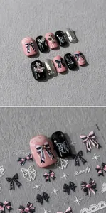 Detail of 3D embossed nail art stickers featuring pink bows and metallic cross designs