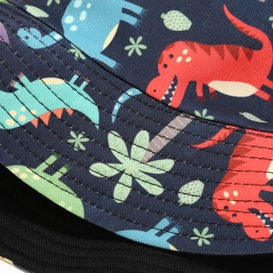 Detail of navy blue bucket hat featuring colorful cartoon dinosaur prints and neat stitching