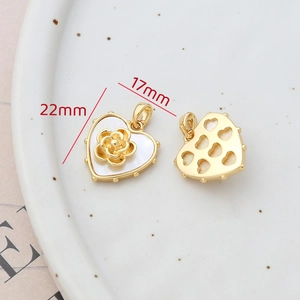 Detailed macro view of 14k gold-filled heart pendant with mother-of-pearl and flower