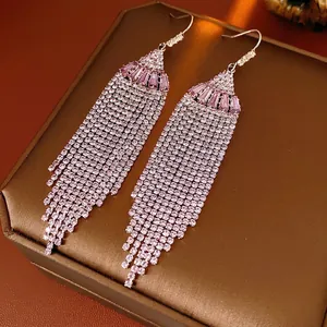 Bohemian fan-shaped tassel earrings with purple zircons and silver finish on jewelry box