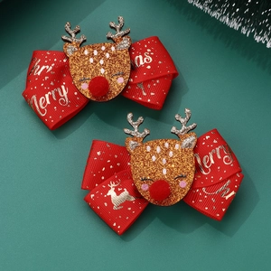 Detail of Christmas reindeer hair clips with glitter fabric and festive red bows
