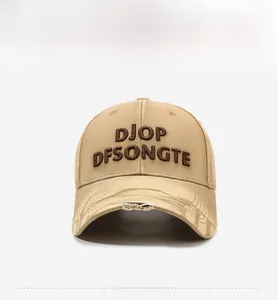 Detail of khaki distressed baseball cap featuring 3D embroidery and frayed brim texture