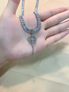 Silver key pendant necklace featuring a rectangle-cut cubic zirconia tennis chain design