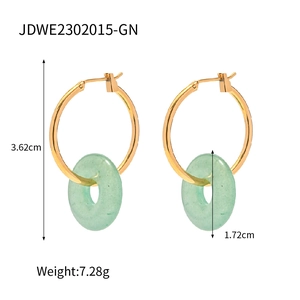 Detail shot of gold titanium steel hoop earrings with green tiger eye donut charms