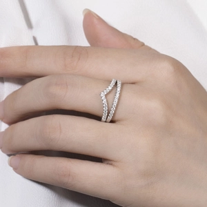 Close-up of elegant V-shaped double-row moissanite ring worn on a finger