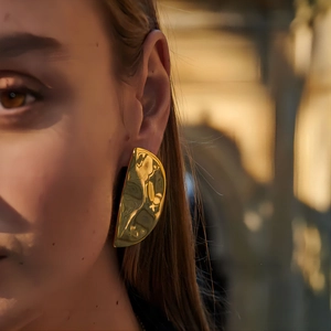 18k gold plated stainless steel crescent earrings with hammered texture on female model