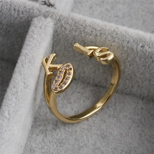 Minimalist gold open ring featuring KISS letter design with zircon stone accents