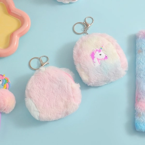 Detail of plush unicorn mini backpacks with rainbow fur and silver metal keychains