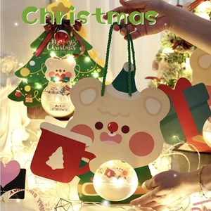 Christmas gift bag featuring cartoon bear and pine tree design with green handle