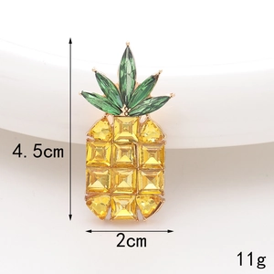 Detailed macro view of a 4.5cm pineapple charm with yellow and green crystals