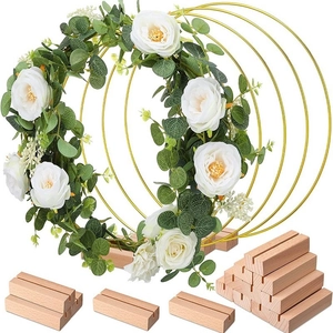 Golden metal floral hoops set with wooden bases and white rose eucalyptus garland