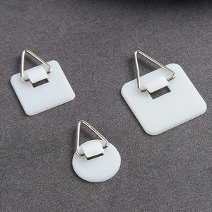 Adhesive square and round plate hangers with white plastic base and metal triangle hooks