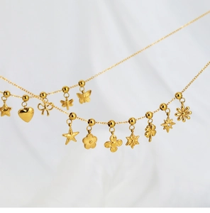 Detailed close-up of various gold stainless steel charms like stars, hearts and flowers