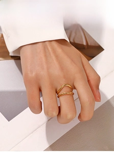 Close-up of 18K gold-plated double-layered ring with wave and twisted rope bands