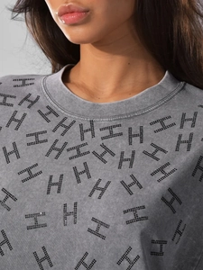 Close-up of vintage grey cotton tee featuring sparkling black rhinestone H pattern