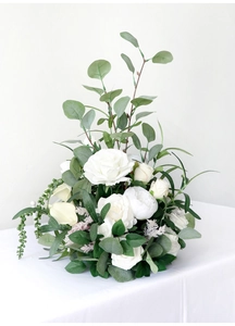 Close-up of artificial white roses and peonies with green eucalyptus leaves for wedding