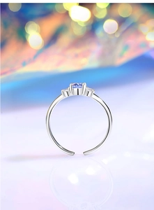 Macro shot of s925 silver ring with purple zircon and three-stone setting detail