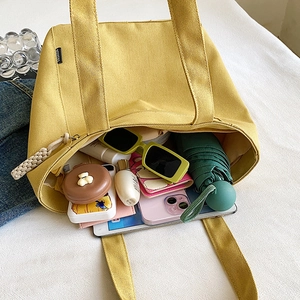 Fashionable yellow canvas tote bag with large capacity and durable black fashion label