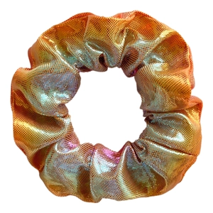 Detail of handmade laser fabric scrunchie with metallic orange and purple gradient texture