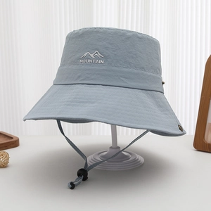 Detail view of quick-dry sun hat with MOUNTAIN logo and adjustable windproof cord