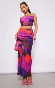 Detail of purple wavy print pleated fabric on a two-piece crop top and maxi skirt set