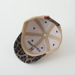 Detailed interior of a kids baseball cap with leopard print brim and brand logo print
