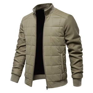 Detail of quilted olive jacket with knitted sleeve texture and metallic zipper