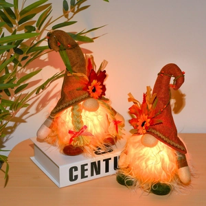Lighted Thanksgiving turkey gnome figurines with autumn maple leaf decorations