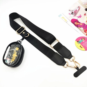 Detail of black nylon phone strap with golden metal clips and clear PVC coin purse pouch