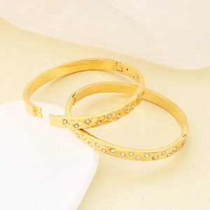 Luxurious 18K gold plated titanium bangles with diamond accents and woven texture