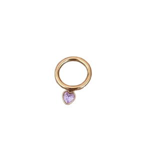 Elegant gold ring with a sparkling heart-shaped purple zircon pendant on white background