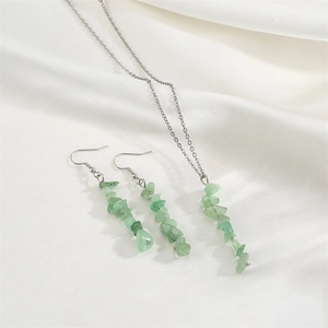 Detailed set of green natural stone chip necklace and matching tassel earrings on silk