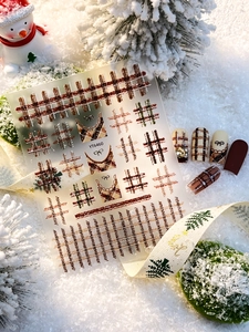 Detail of Christmas plaid nail stickers YT6460 with bows on warm winter background
