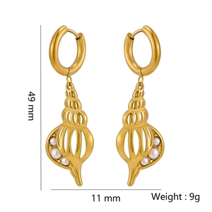 Detail view of gold seashell earrings with white pearl and size dimensions 49mm by 11mm