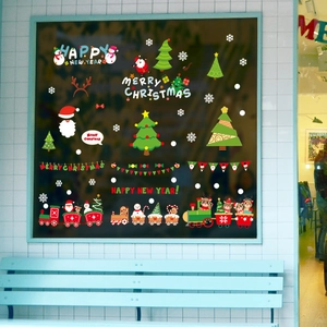 Christmas window decals with Santa Claus and Merry Christmas text on dark glass
