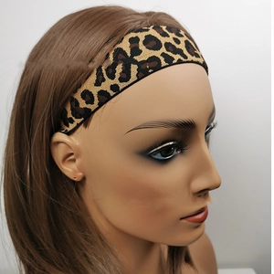 Elastic leopard print wig grip headband with adjustable strap on a mannequin head
