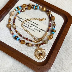Ethnic stainless steel necklace with sun pendant, tiger eye stones and colorful beads