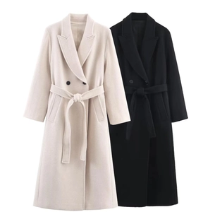 Detail of long wool coat with wide lapels, double-breasted buttons and matching waist belt