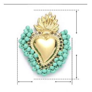 Detail view of heart pendant with mint green beads and golden stainless steel finish