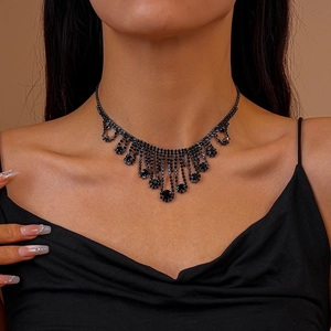 Close-up detail of vintage choker necklace with black rhinestones and cascading fringes