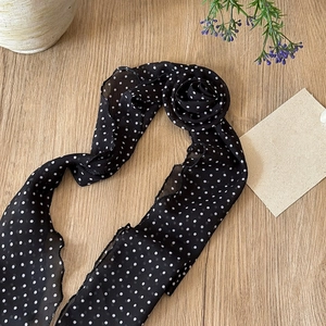 Detail of French retro black and white polka dot silk scarf necklace with fabric rose