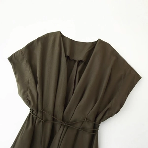 Deep olive green V-neck waist-tie dress with pleated drop shoulder and woven texture